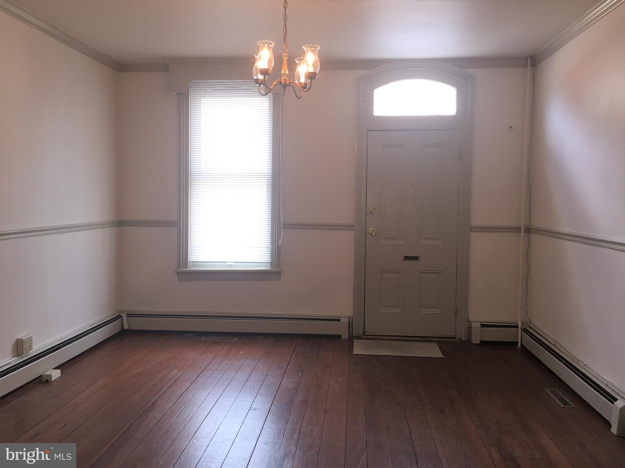 146 West Patrick Street Frederick, MD 21701 - Photo 4 of 20 an empty room with wooden floor and windows