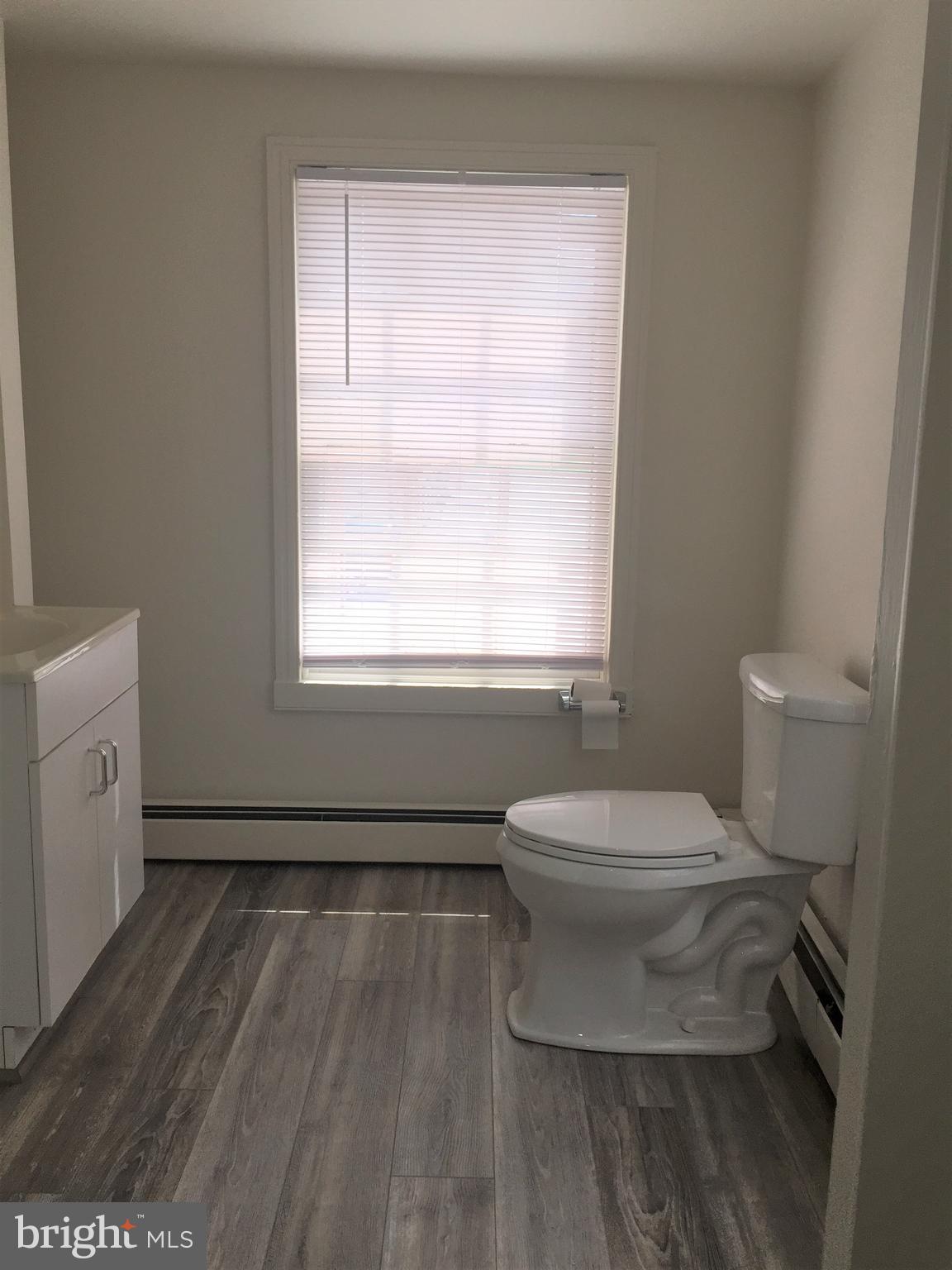 146 West Patrick Street Frederick, MD 21701 - Photo 8 of 20 a bathroom with a toilet sink and a window