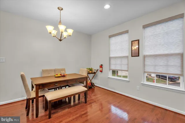 a view of a dining room with furniture wooden floor and chandelier