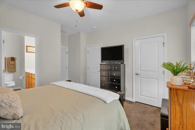 a bedroom with a bed and a television