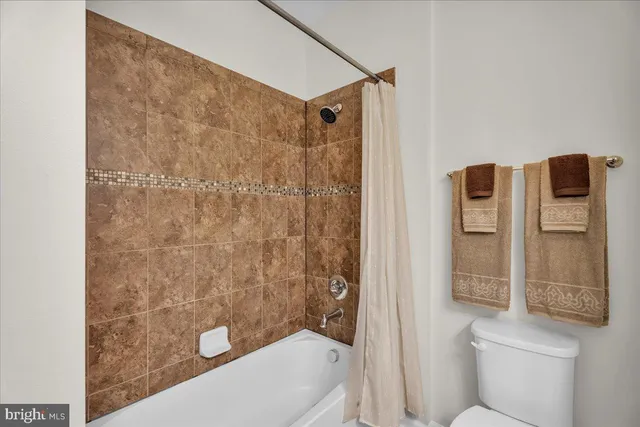 a bathroom with a toilet and shower
