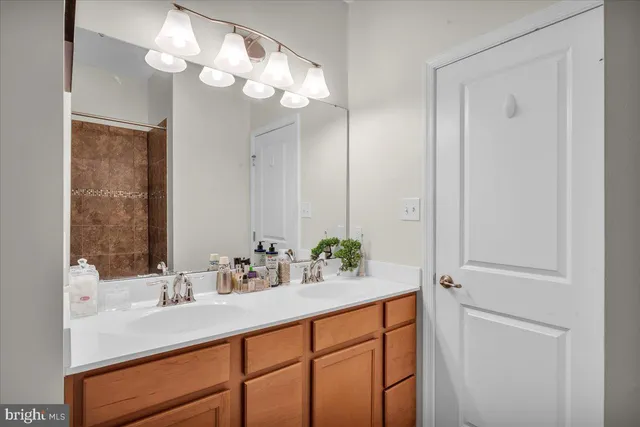 a bathroom with a sink a light fixture and a mirror