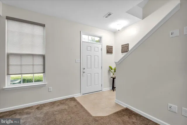 a view of an entryway with wooden floor and windows
