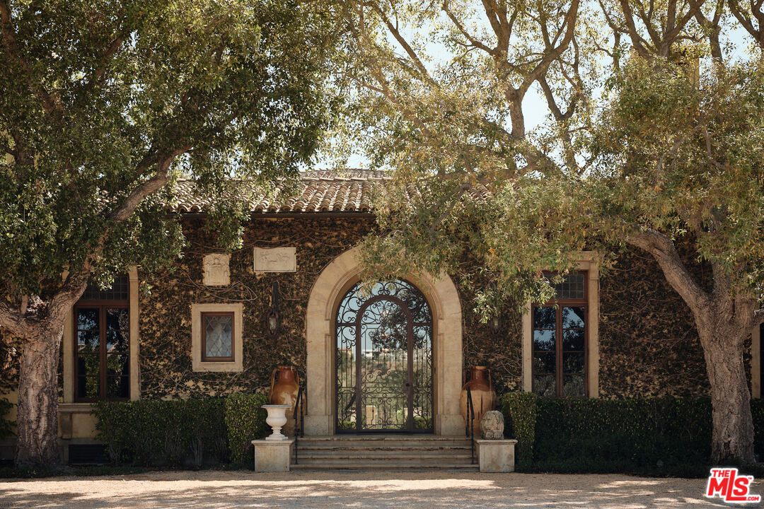10939 Chalon Road Los Angeles, CA 90077 - Photo 4 of 24 a view of a brick building with large windows