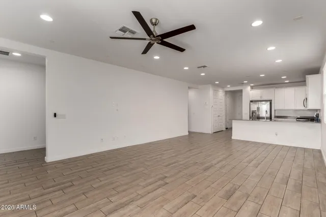 a kitchen with refrigerator and cabinets