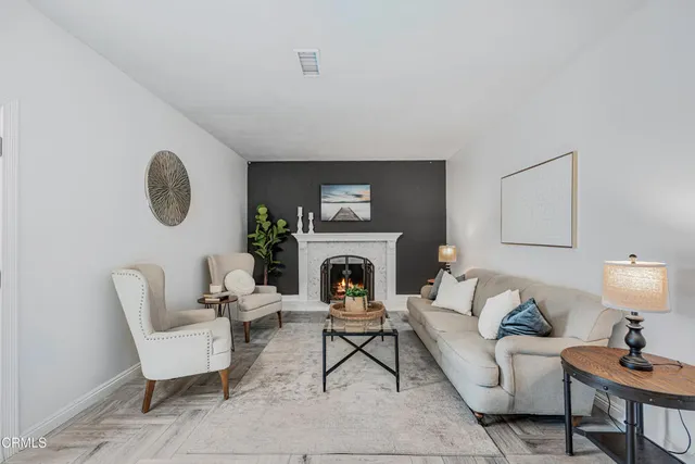 a living room with furniture and a fireplace