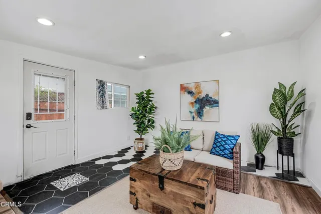 a living room with furniture and a potted plant