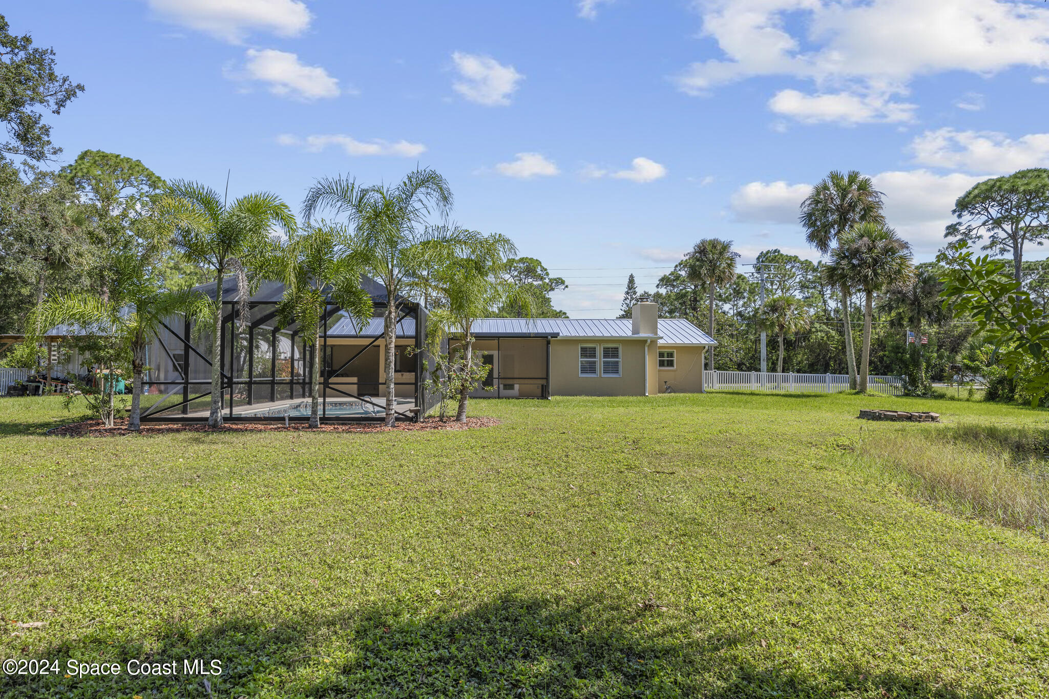 2260 Harlock Road Melbourne, FL 32934 - Photo 38 of 49 a view of a house with a big yard and large trees