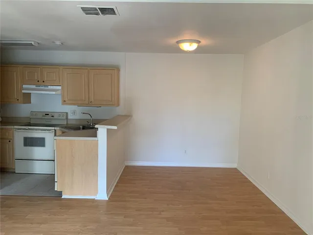 a kitchen with a sink cabinets and stainless steel appliances