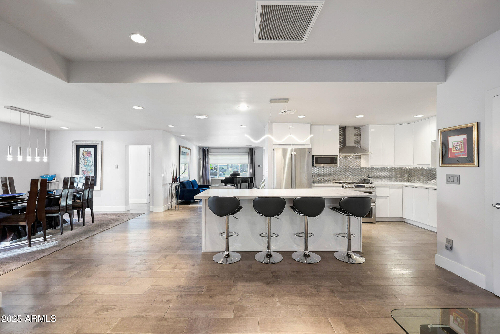 4435 North 35th Street Phoenix, AZ 85018 - Photo 2 of 35 a kitchen with stainless steel appliances kitchen island granite countertop a dining table chairs and granite counter tops