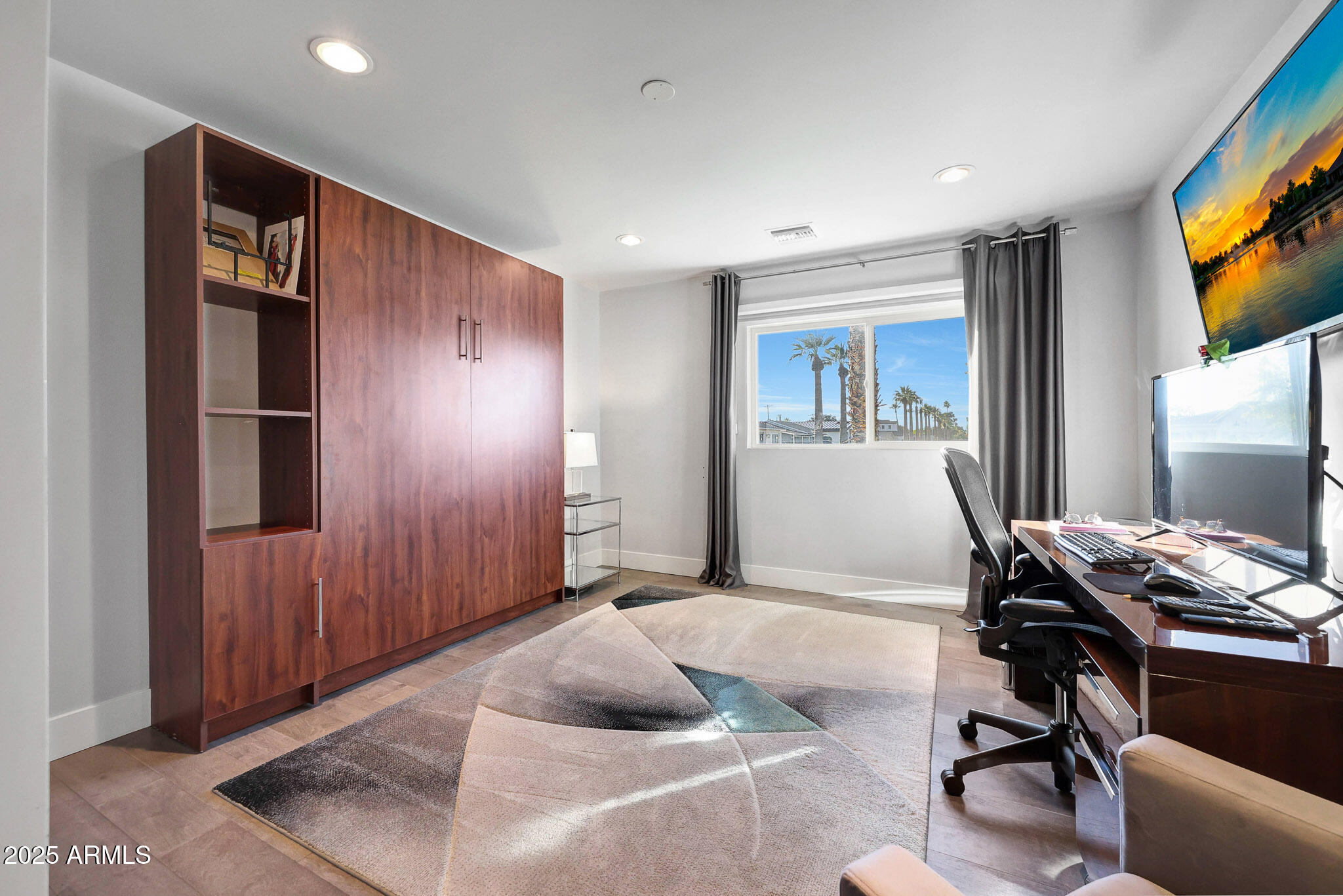 4435 North 35th Street Phoenix, AZ 85018 - Photo 27 of 35 a bedroom with a bed and a flat screen tv