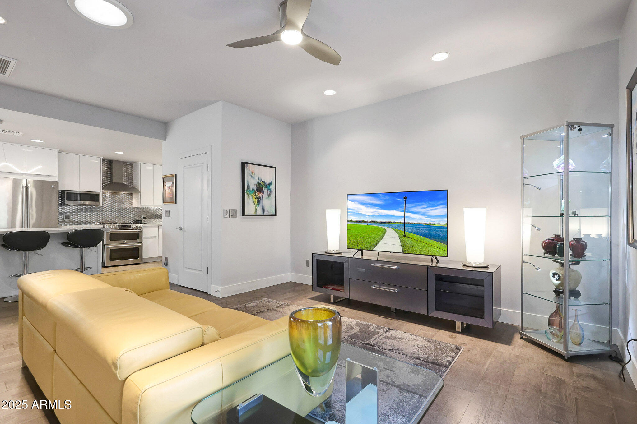 4435 North 35th Street Phoenix, AZ 85018 - Photo 5 of 35 a living room with furniture a flat screen tv and kitchen view