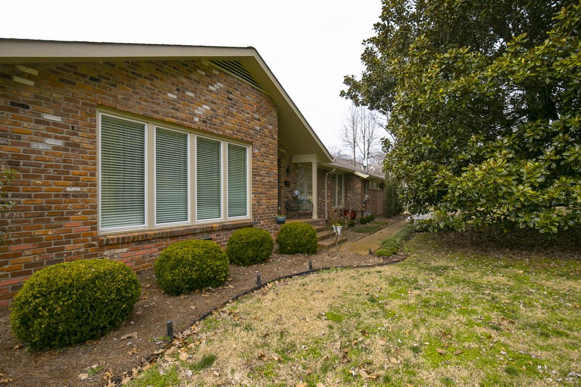 885 Holly Tree Gap Road Brentwood, TN 37027 - Photo 1 of 28 a front view of a house with garden