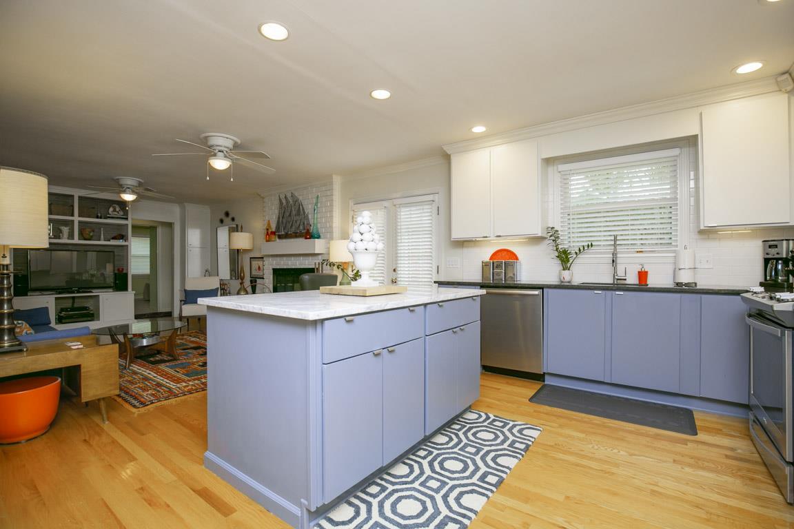 885 Holly Tree Gap Road Brentwood, TN 37027 - Photo 10 of 28 a kitchen with stainless steel appliances granite countertop a sink stove and cabinets