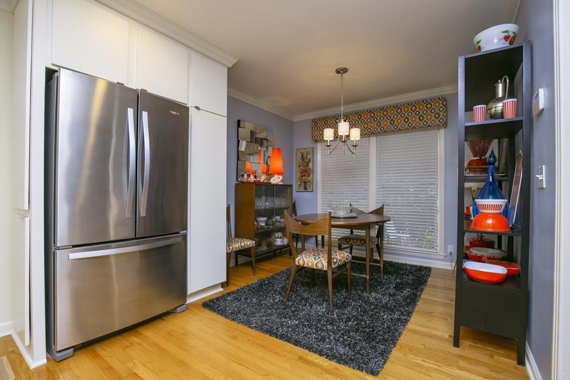885 Holly Tree Gap Road Brentwood, TN 37027 - Photo 12 of 28 a kitchen with stainless steel appliances granite countertop a refrigerator dining table and chairs