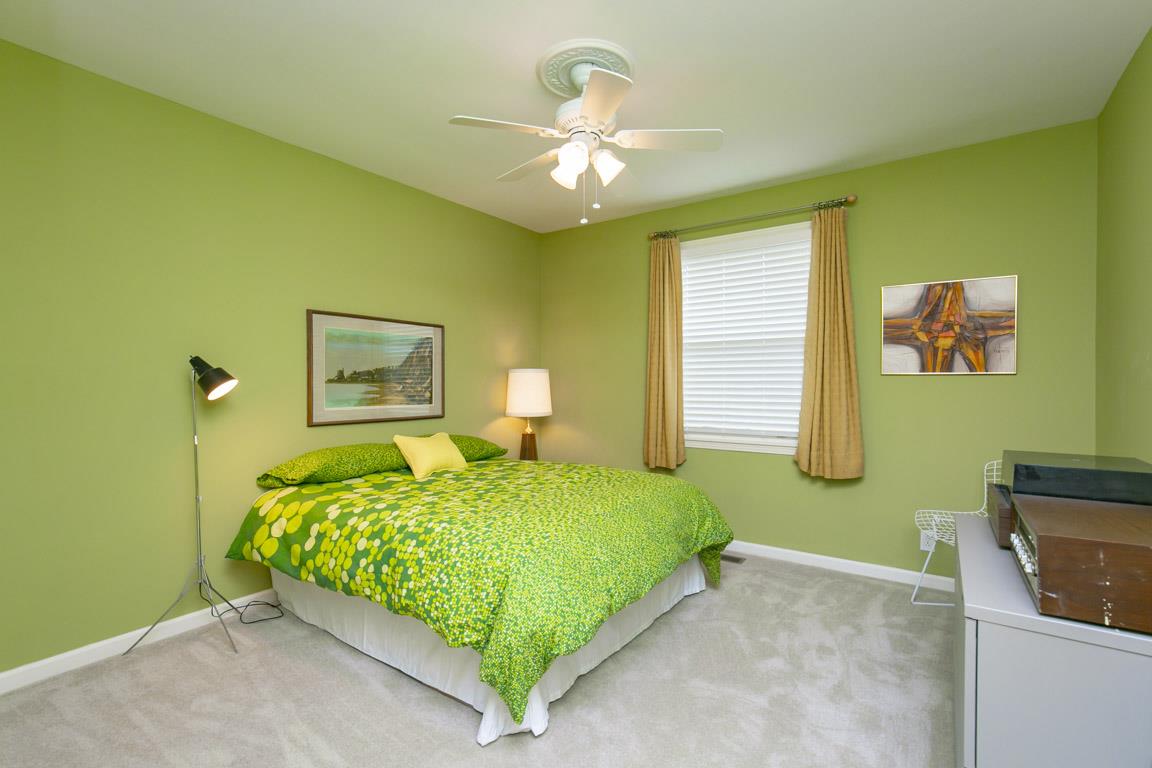 885 Holly Tree Gap Road Brentwood, TN 37027 - Photo 14 of 28 a bedroom with a bed and a chandelier