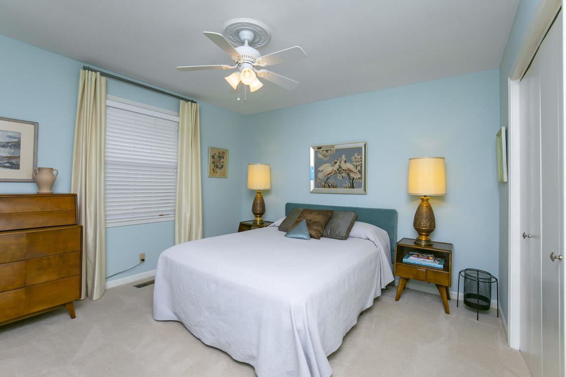 885 Holly Tree Gap Road Brentwood, TN 37027 - Photo 16 of 28 a bedroom with a bed and a chandelier