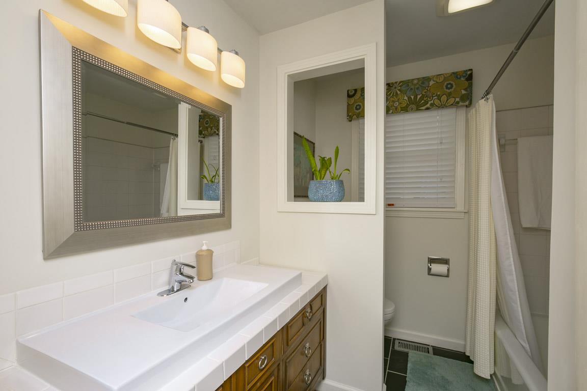 885 Holly Tree Gap Road Brentwood, TN 37027 - Photo 18 of 28 a bathroom with a sink and a mirror