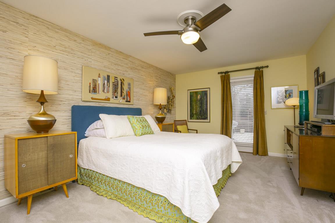 885 Holly Tree Gap Road Brentwood, TN 37027 - Photo 19 of 28 a bedroom with a bed and a chandelier