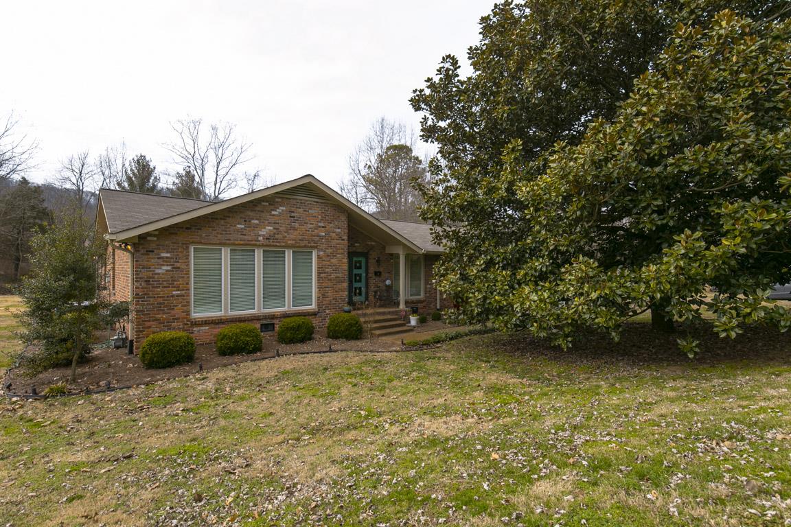 885 Holly Tree Gap Road Brentwood, TN 37027 - Photo 2 of 28 a front view of a house with garden