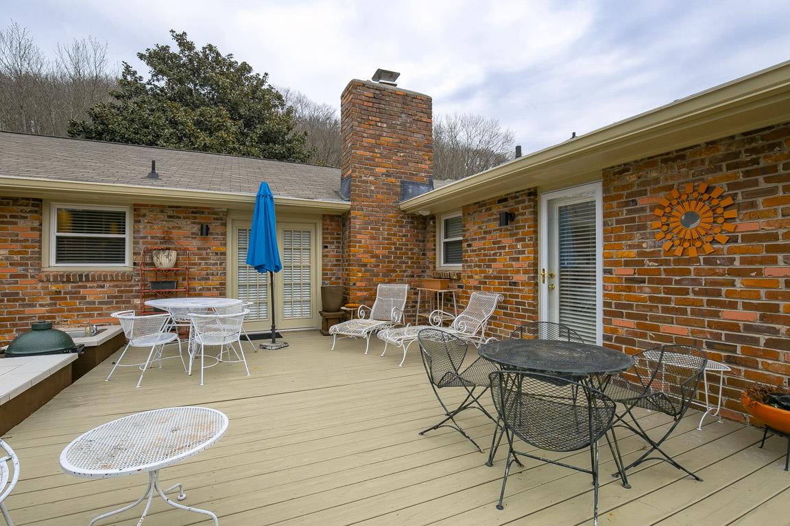 885 Holly Tree Gap Road Brentwood, TN 37027 - Photo 24 of 28 a view of a patio with table and chairs with wooden floor and fence