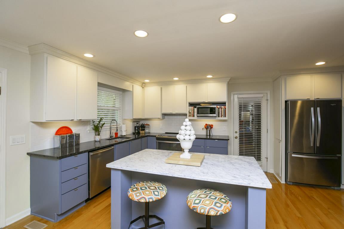 885 Holly Tree Gap Road Brentwood, TN 37027 - Photo 8 of 28 a kitchen with stainless steel appliances granite countertop a sink a stove and a refrigerator