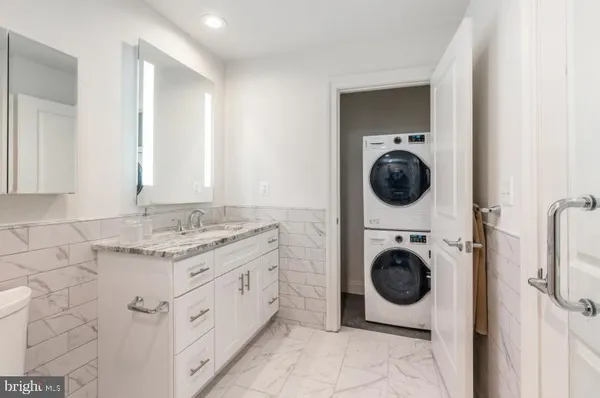 a bathroom with a sink a washer and dryer