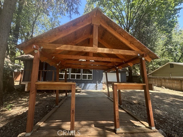 14301 Sinclair Circle Magalia, CA 95954 - Photo 4 of 13 a view of a patio with table and chairs under an umbrella