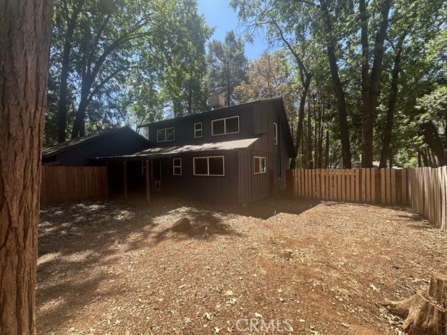 14301 Sinclair Circle Magalia, CA 95954 - Photo 7 of 13 a backyard of a house with table and chairs under an umbrella