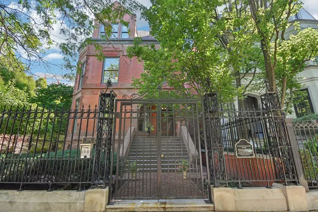 a front view of a house with a iron stairs