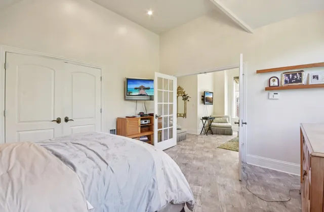 a living room with furniture a large window and dining table