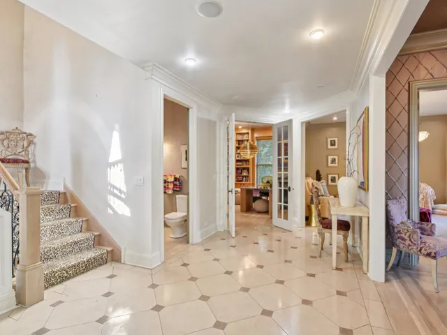 a living room with furniture a fireplace and a chandelier