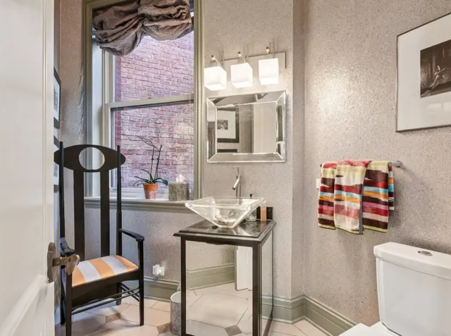 a bedroom with furniture and a chandelier