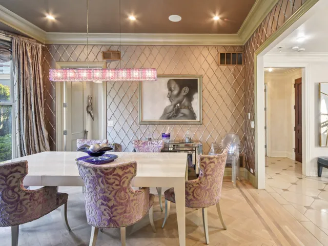 a living room with furniture large window and chairs