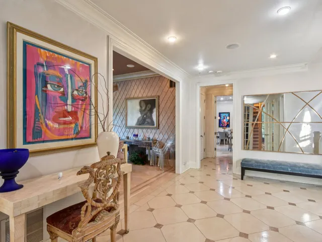 a living room with furniture and kitchen view