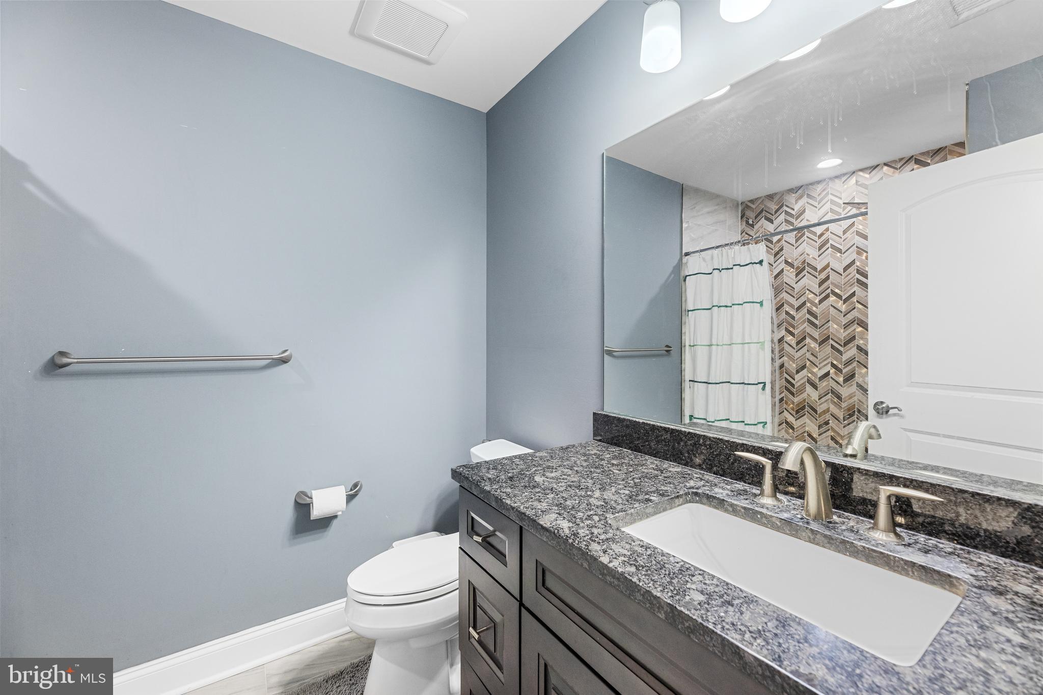 22 Samjan Circle Hightstown, NJ 08520 - Photo 21 of 31 a bathroom with a granite countertop sink a toilet and shower