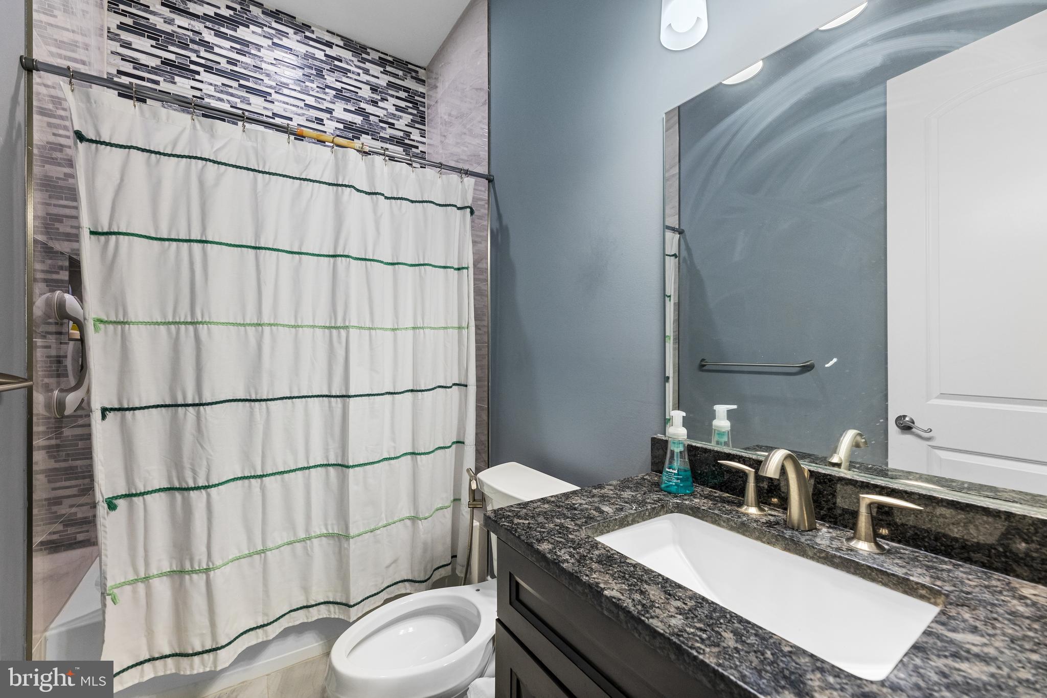 22 Samjan Circle Hightstown, NJ 08520 - Photo 28 of 31 a bathroom with a granite countertop toilet sink and mirror