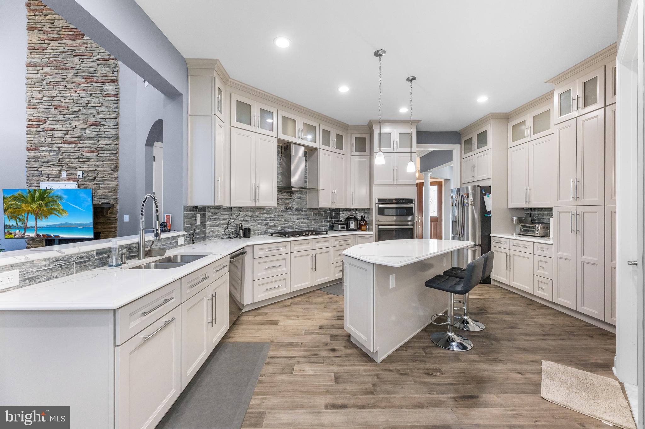 22 Samjan Circle Hightstown, NJ 08520 - Photo 9 of 31 a large white kitchen with kitchen island a sink appliances and cabinets
