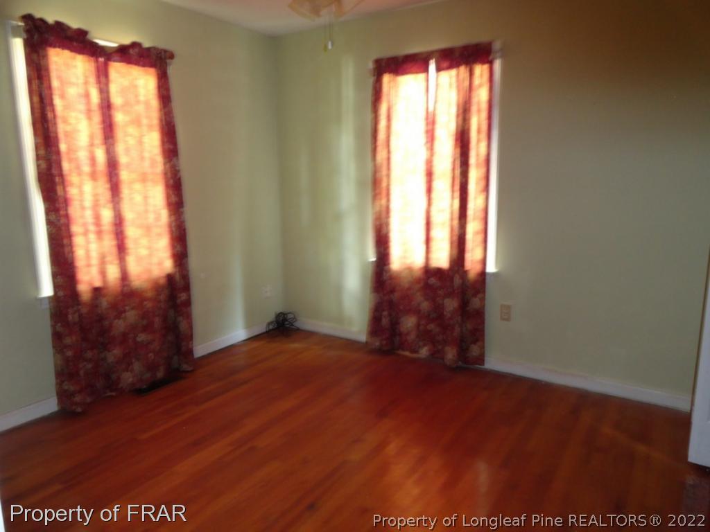 5048 Cameron Road Hope Mills, NC 28348 - Photo 8 of 15 an empty room with wooden floor and windows
