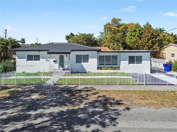 a front view of house with deck and yard