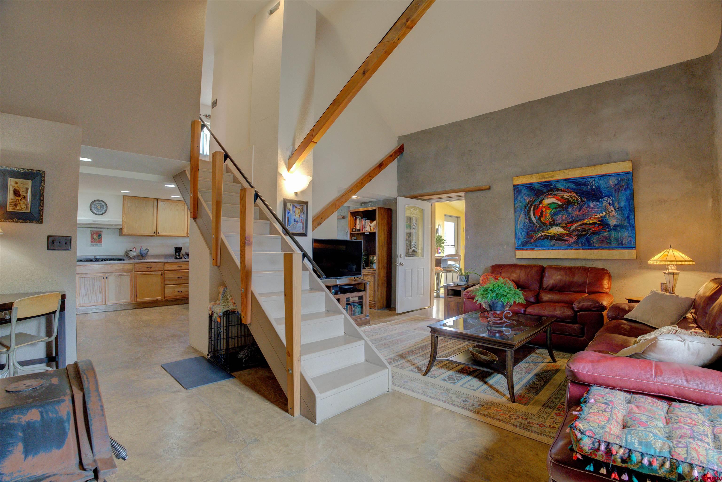 a living room with furniture and a painting