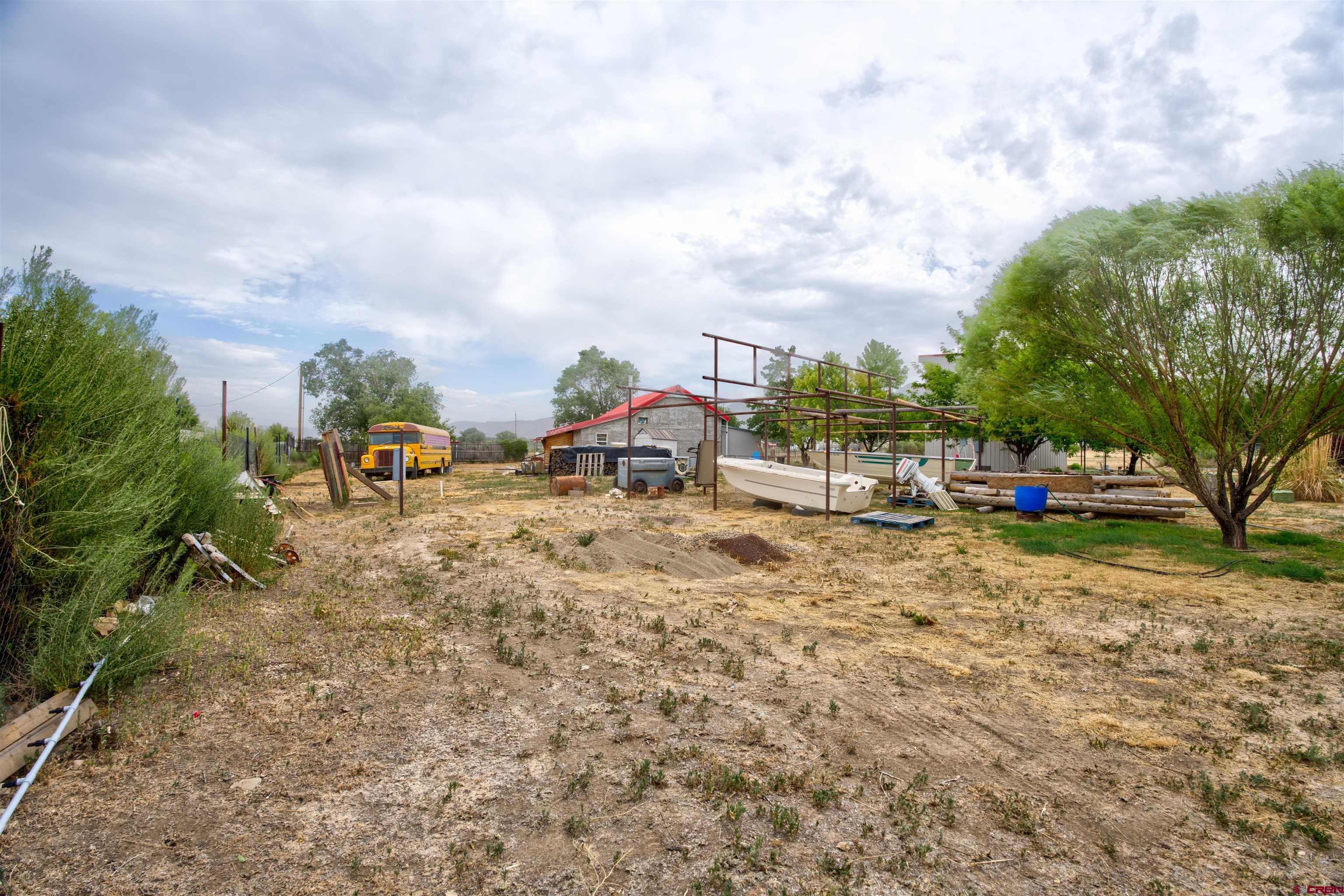 6597 Road 23 Cortez, CO 81321 - Photo 12 of 38 a view of a yard with table and chairs and potted plants