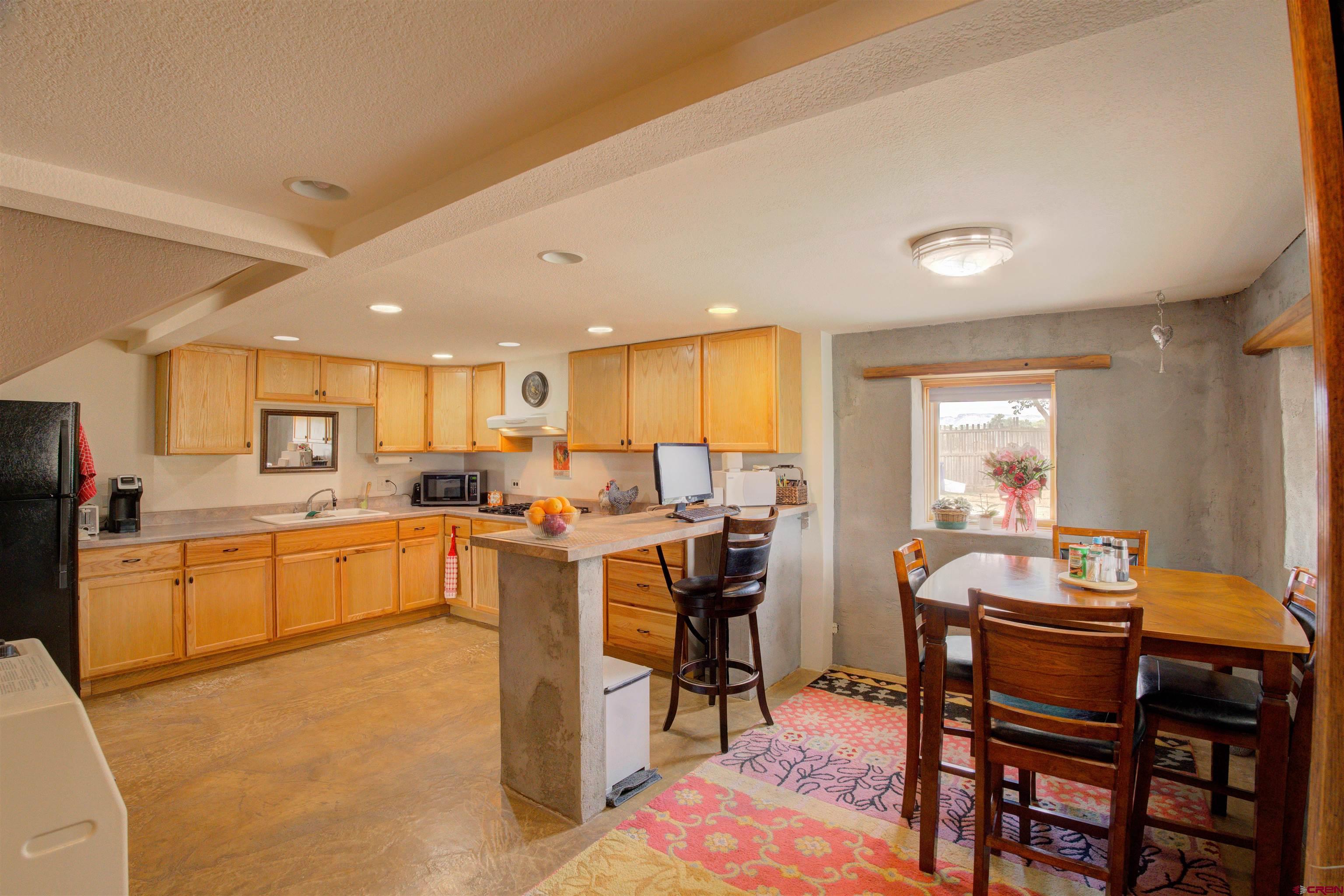 6597 Road 23 Cortez, CO 81321 - Photo 19 of 38 a view of a dining room with furniture and window