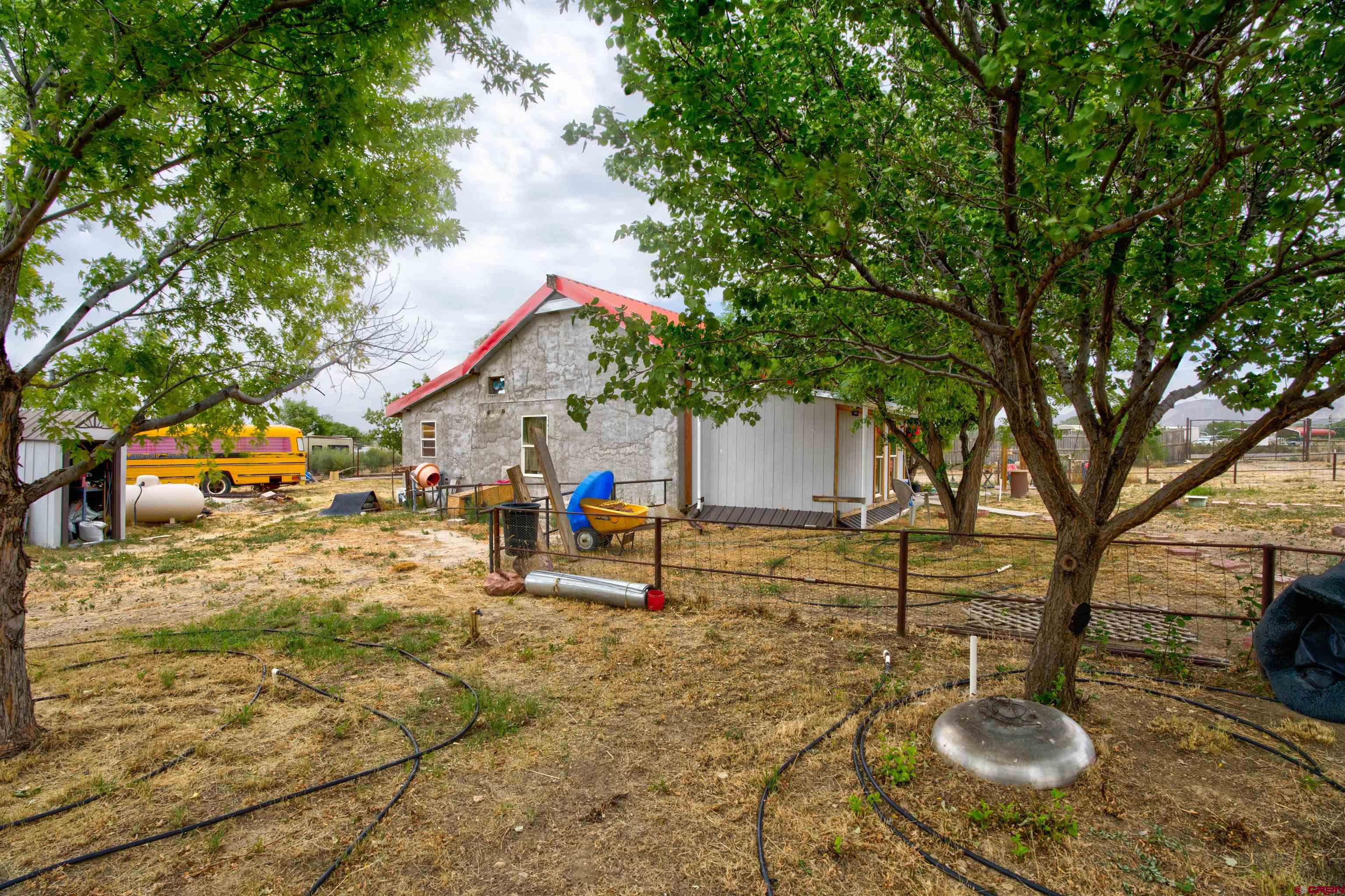 6597 Road 23 Cortez, CO 81321 - Photo 20 of 38 a backyard of a house with table and chairs