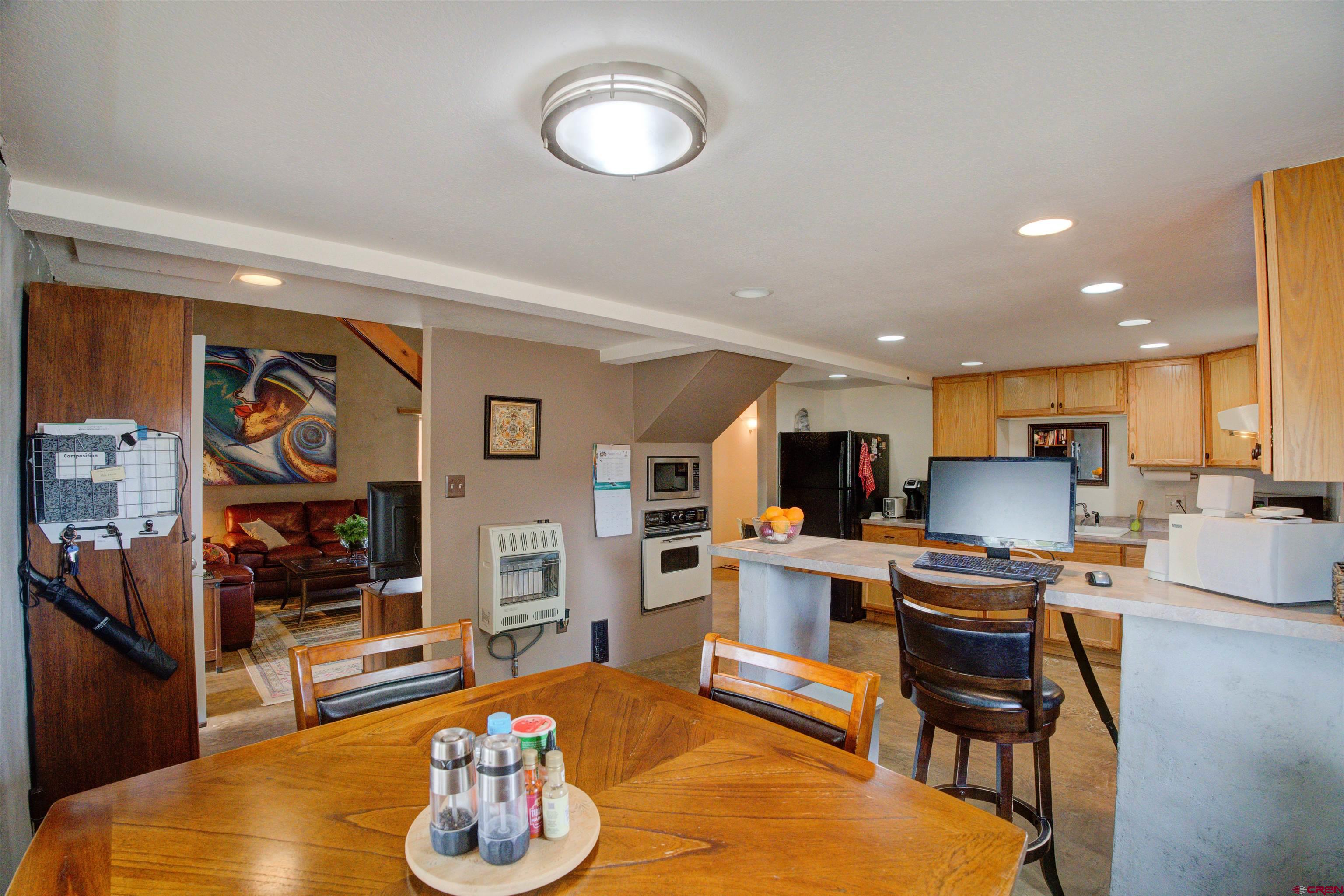 6597 Road 23 Cortez, CO 81321 - Photo 20 of 38 a living room with stainless steel appliances kitchen island granite countertop furniture and a wooden floor