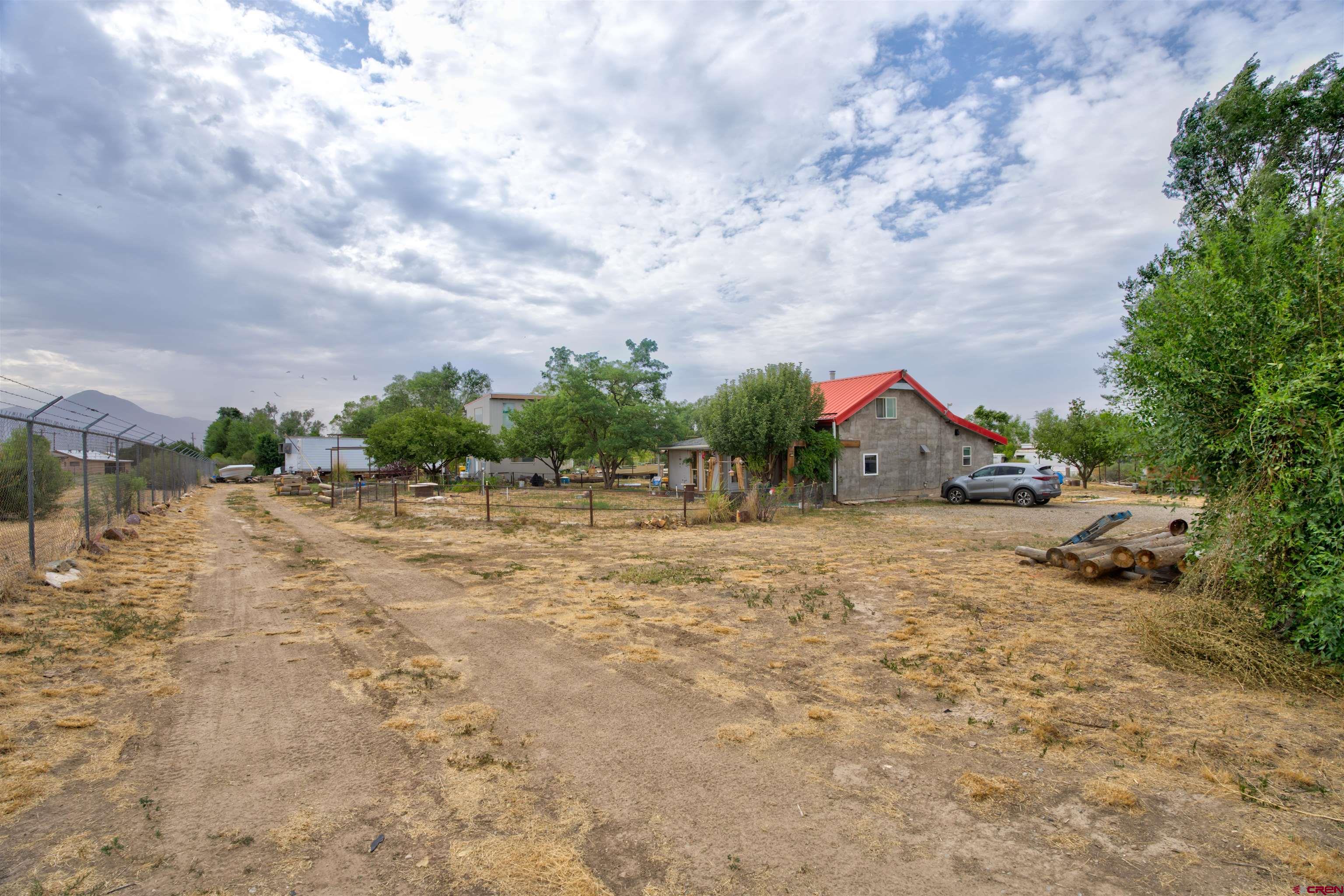 6597 Road 23 Cortez, CO 81321 - Photo 2 of 38 a backyard of a house with lots of green space