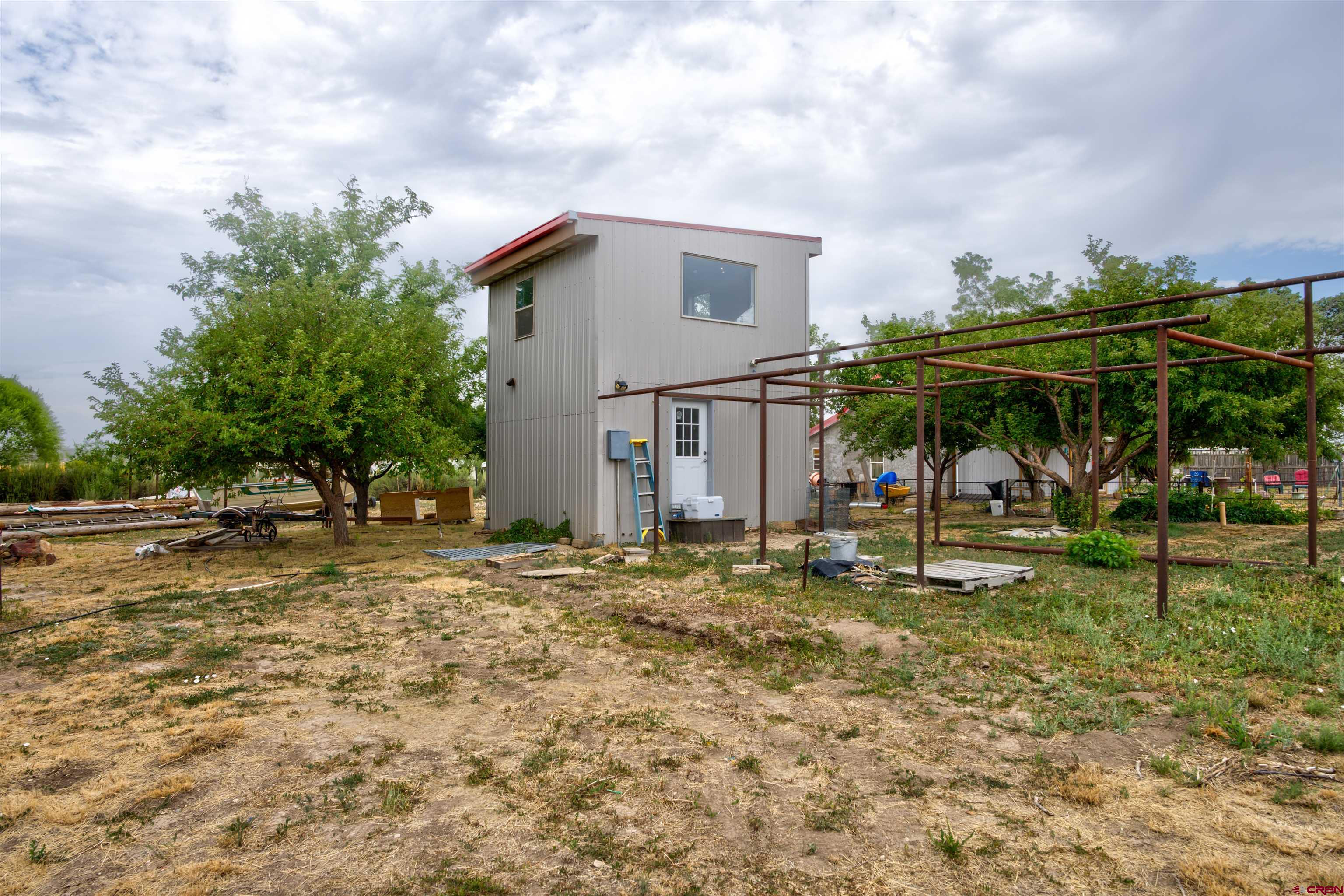 6597 Road 23 Cortez, CO 81321 - Photo 24 of 38 a view of a house with a yard and sitting area