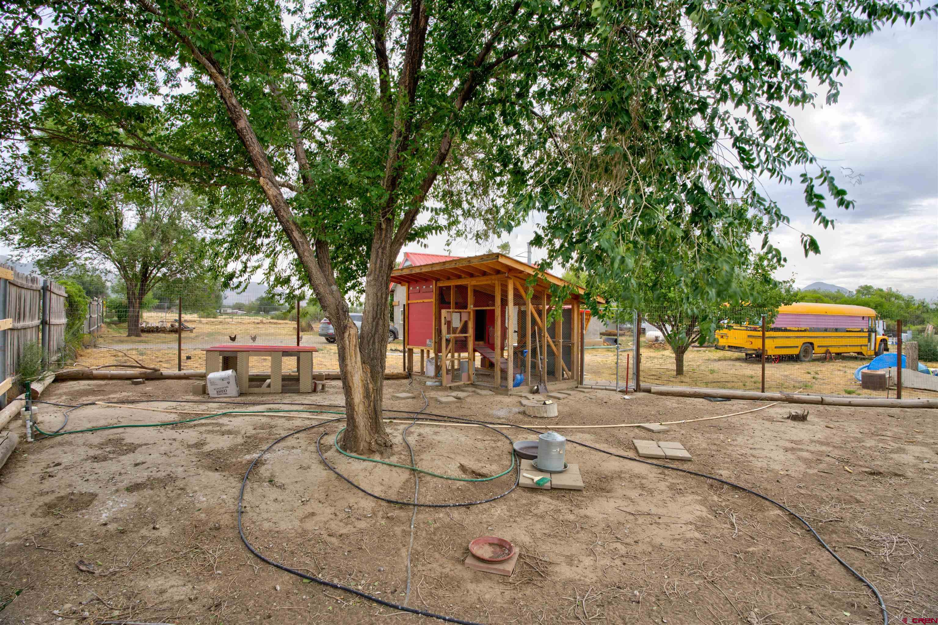 6597 Road 23 Cortez, CO 81321 - Photo 27 of 38 a front view of a house with garden and trees