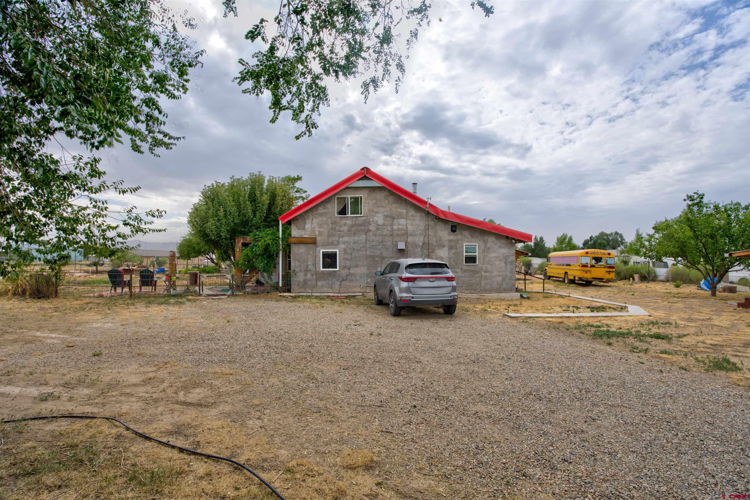 6597 Road 23 Cortez, CO 81321 - Photo 3 of 38 a car parked in front of white house