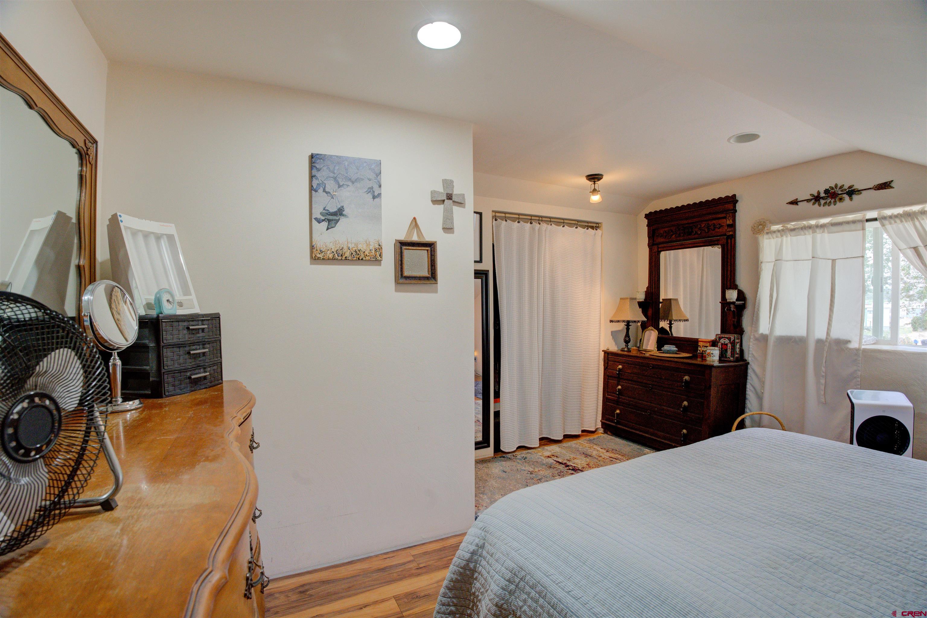 6597 Road 23 Cortez, CO 81321 - Photo 34 of 38 a bedroom with a bed and a flat tv screen on dresser